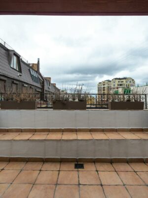 Veranda with potted plants under cloudy sky